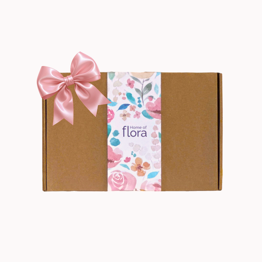 Gift box with a pink bow and floral design on a white background