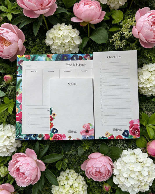 Floral planner with checklists on a background of pink and white flowers